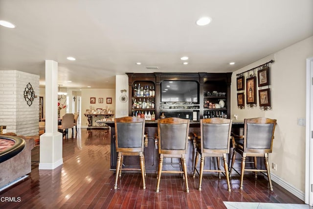 bar with dark wood-type flooring