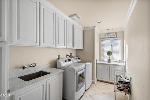 laundry room featuring sink, cabinets, crown molding, light tile patterned flooring, and washer and dryer