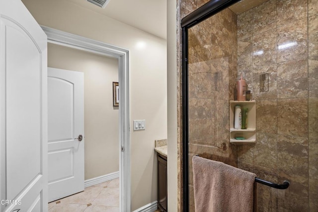 bathroom with tile patterned floors, vanity, and a shower with shower door