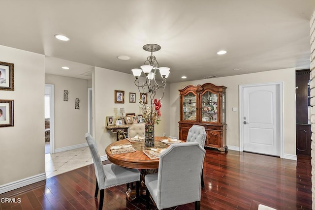 dining space featuring a chandelier and dark wood-type flooring