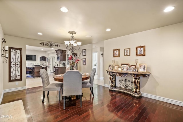 dining room featuring dark hardwood / wood-style floors and a chandelier