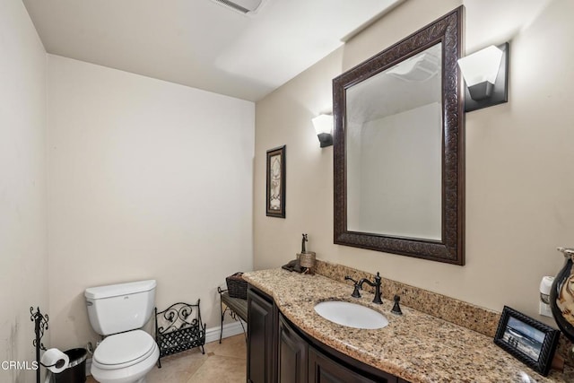 bathroom featuring tile patterned floors, vanity, and toilet