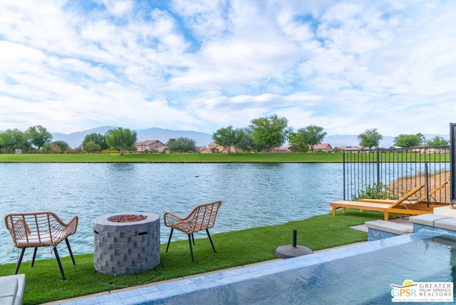 property view of water with a mountain view and a fire pit