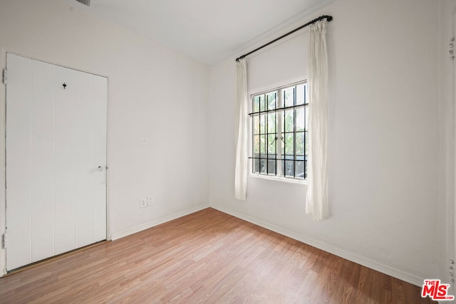 spare room with light wood-type flooring