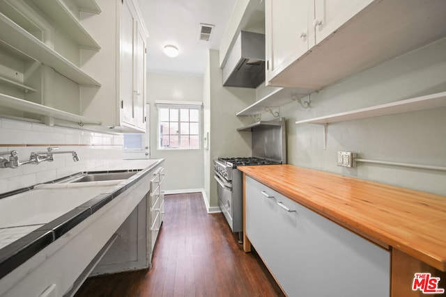 kitchen with wood counters, tasteful backsplash, dark hardwood / wood-style flooring, high end stainless steel range, and white cabinets