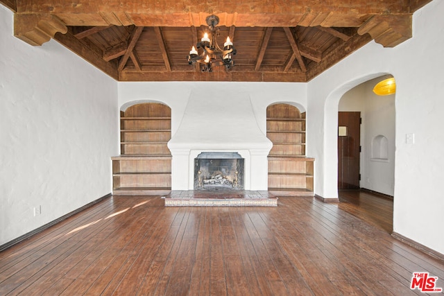 unfurnished living room with built in features, wooden ceiling, and dark wood-type flooring