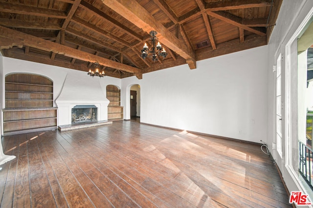 unfurnished living room featuring beam ceiling, wooden ceiling, a notable chandelier, and hardwood / wood-style floors