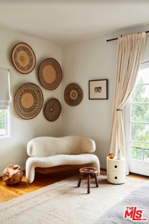 sitting room featuring a healthy amount of sunlight and wood-type flooring