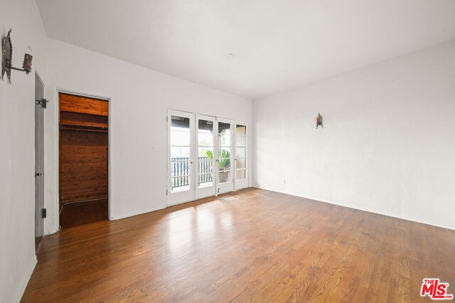 unfurnished room featuring hardwood / wood-style floors and french doors