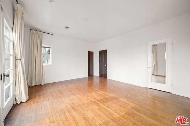 spare room with wood-type flooring