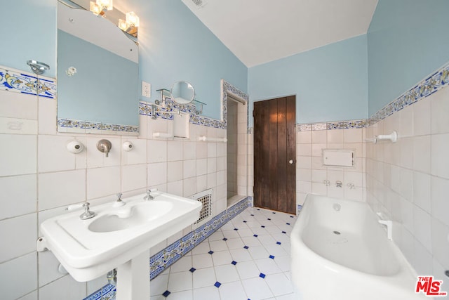 bathroom featuring a bath and tile walls