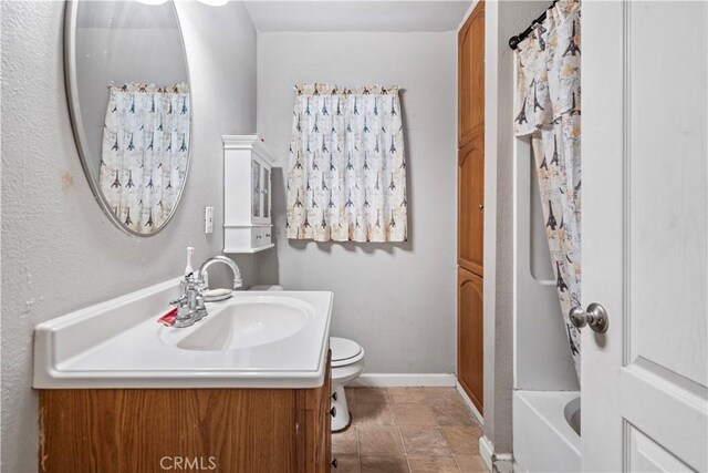 full bathroom with tile patterned floors, vanity,  shower combination, and toilet