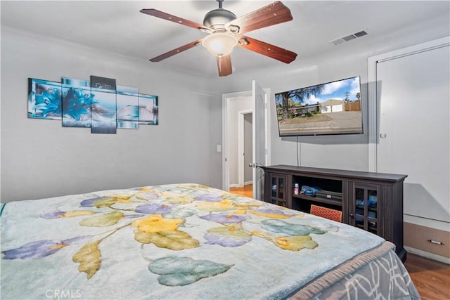 bedroom with ceiling fan and wood-type flooring