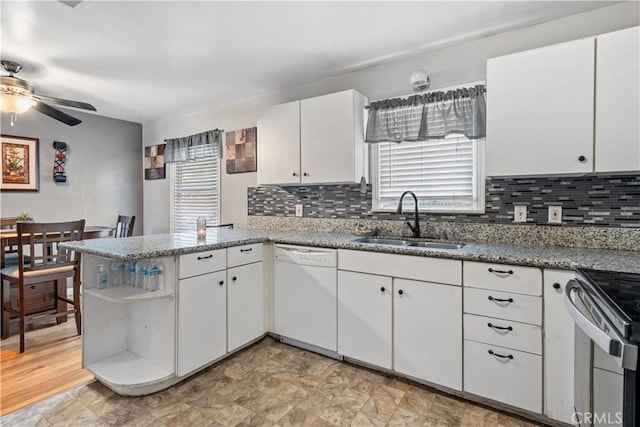 kitchen with dishwasher, sink, kitchen peninsula, ceiling fan, and white cabinetry