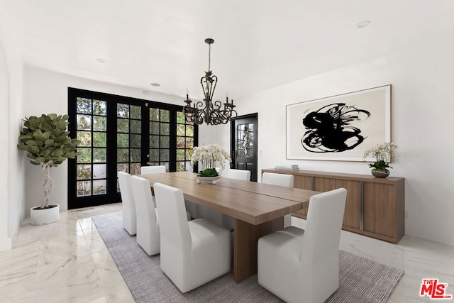 dining space featuring a chandelier and french doors