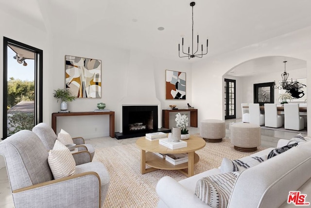 living room with a fireplace and an inviting chandelier