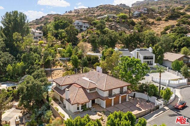 birds eye view of property featuring a mountain view