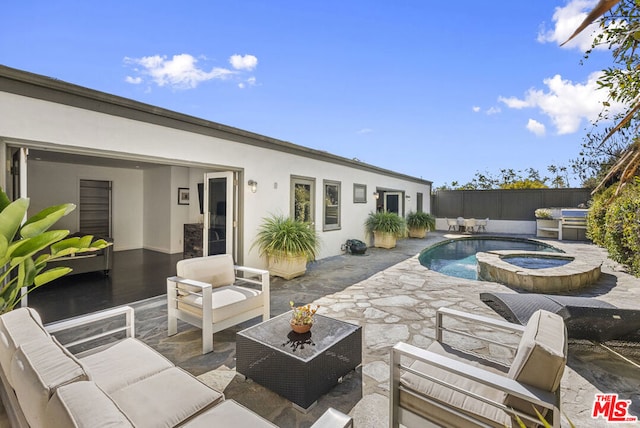 view of pool with an in ground hot tub, outdoor lounge area, and a patio