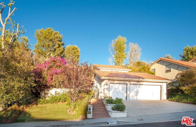 view of front of home featuring a garage and a front lawn