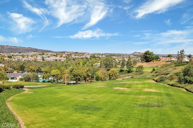 view of community with a lawn and a mountain view