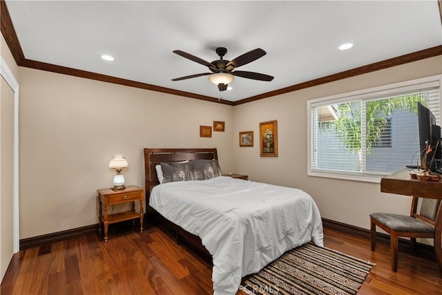 bedroom featuring dark hardwood / wood-style flooring, ceiling fan, and crown molding