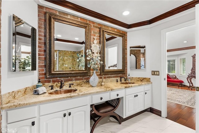 bathroom featuring hardwood / wood-style floors, vanity, and crown molding