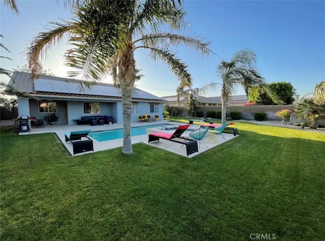 view of pool featuring a yard, grilling area, and a patio area