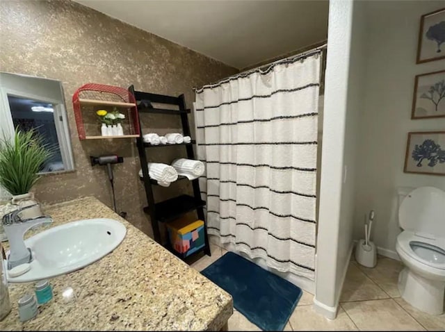 bathroom featuring tile patterned floors, curtained shower, vanity, and toilet