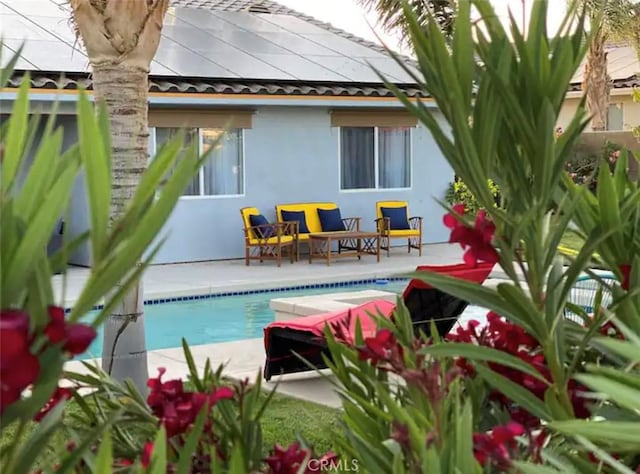 back of house featuring a patio area and solar panels