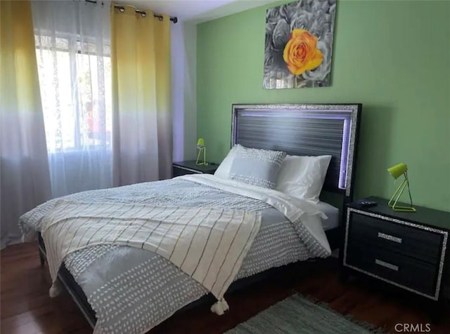 bedroom with dark wood-type flooring