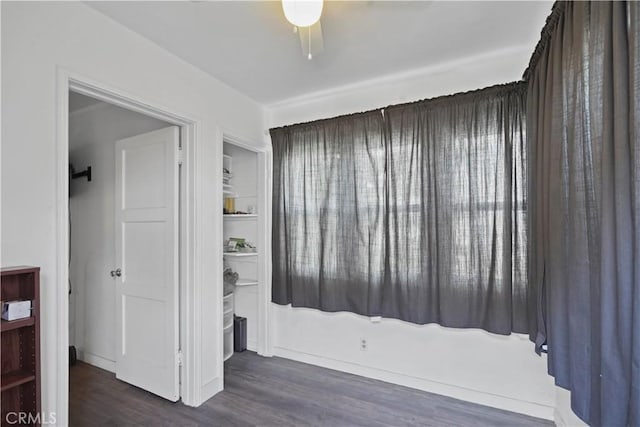 bedroom with ceiling fan and dark wood-type flooring