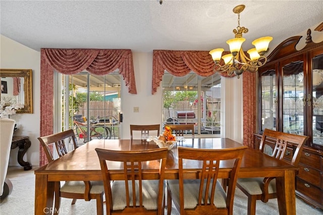 carpeted dining area featuring plenty of natural light and a textured ceiling