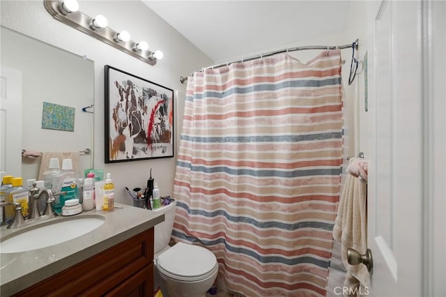 bathroom featuring walk in shower, vanity, and toilet