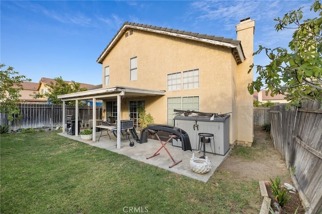 back of house featuring a yard and a patio area