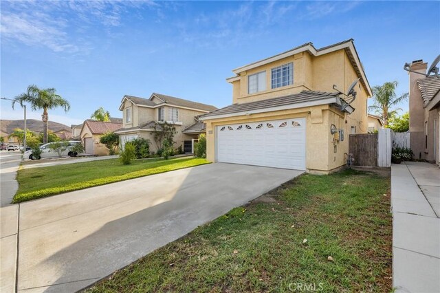 view of property featuring a front yard and a garage