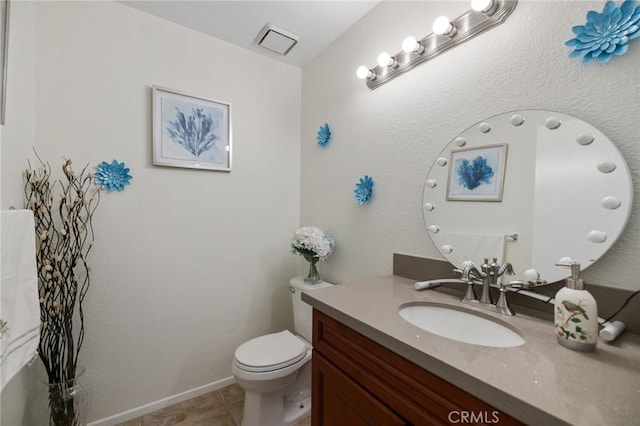 bathroom with tile patterned flooring, vanity, and toilet