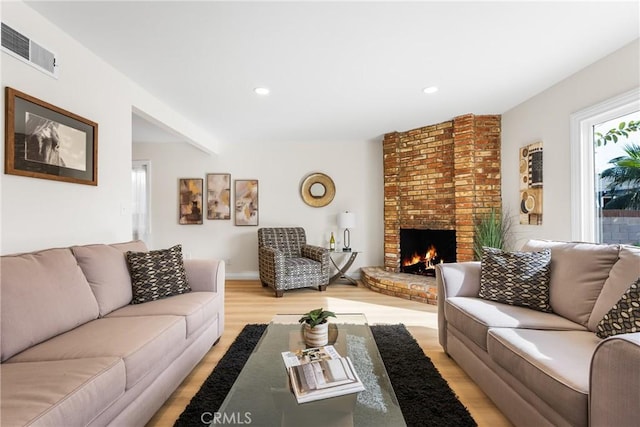 living room featuring a fireplace and light hardwood / wood-style floors