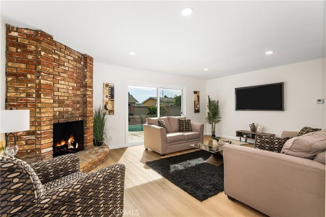 living room featuring a fireplace and light hardwood / wood-style floors