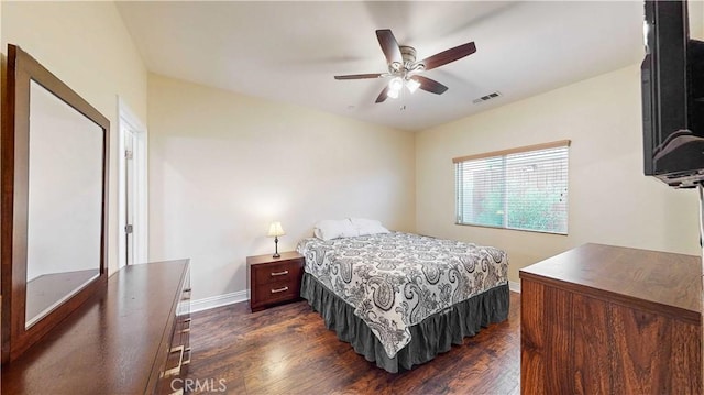 bedroom with ceiling fan and dark hardwood / wood-style floors