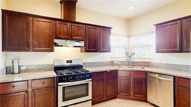 kitchen with light stone countertops, sink, light tile patterned floors, and stainless steel appliances