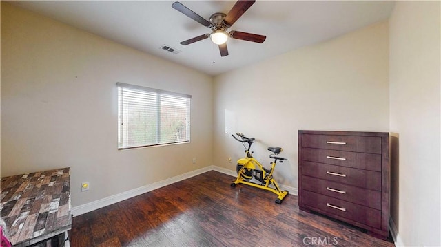 misc room with ceiling fan and dark wood-type flooring