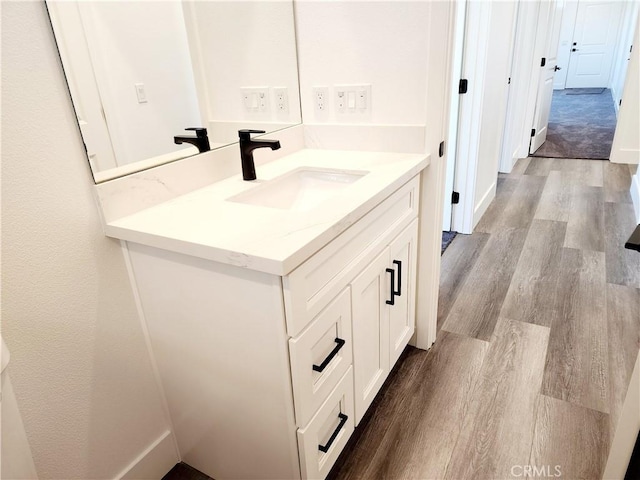 bathroom with hardwood / wood-style flooring and vanity