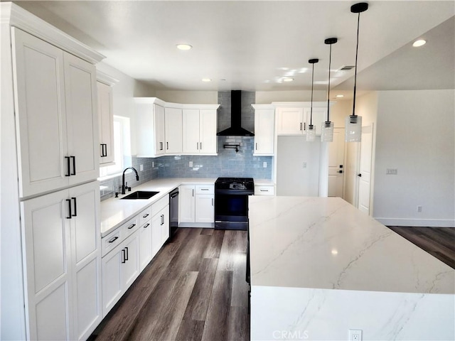 kitchen with wall chimney range hood, a center island, black appliances, sink, and white cabinets