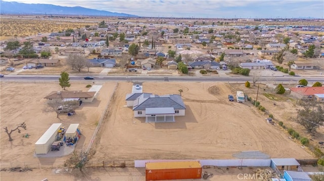 birds eye view of property featuring a mountain view and view of desert