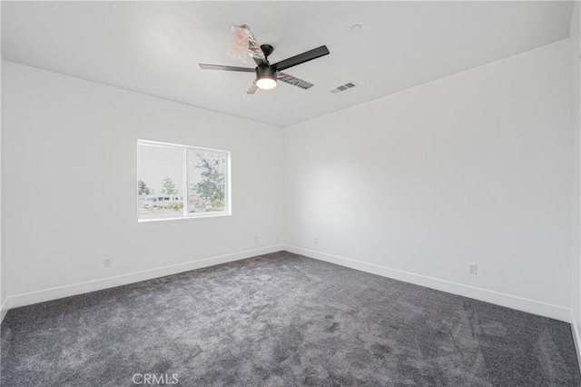 spare room featuring baseboards, carpet floors, visible vents, and a ceiling fan