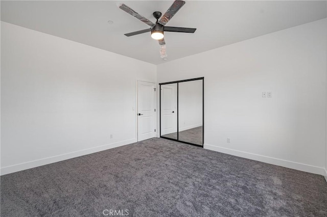 unfurnished bedroom with carpet, a closet, ceiling fan, and baseboards