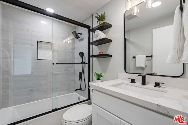 full bathroom with vanity, toilet, and enclosed tub / shower combo