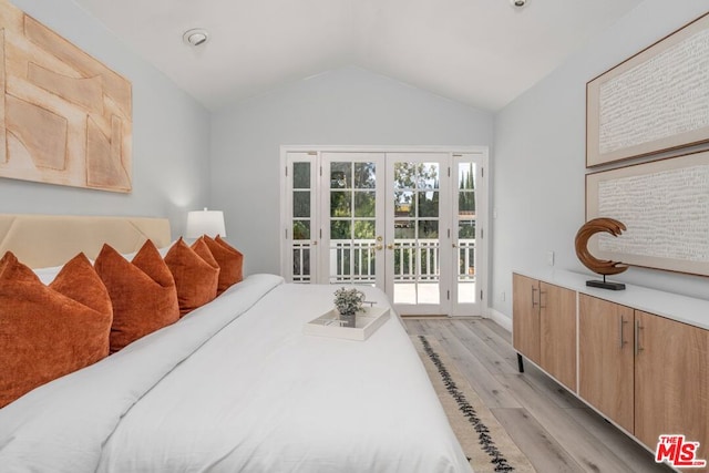 bedroom featuring access to outside, french doors, lofted ceiling, and light wood-type flooring