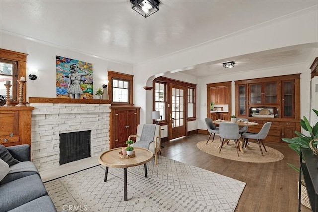 living room featuring dark hardwood / wood-style flooring, a fireplace, and french doors