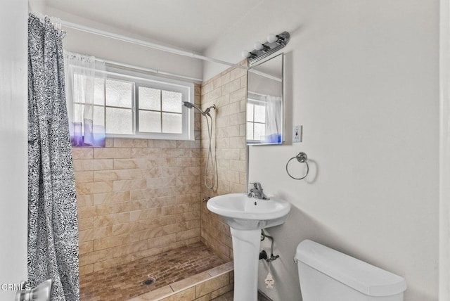 bathroom with toilet and curtained shower